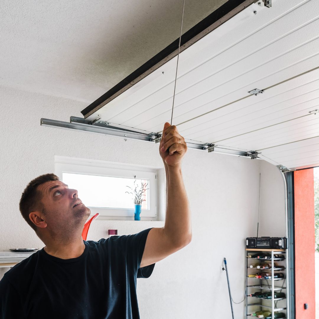 Man tinkering with garage door