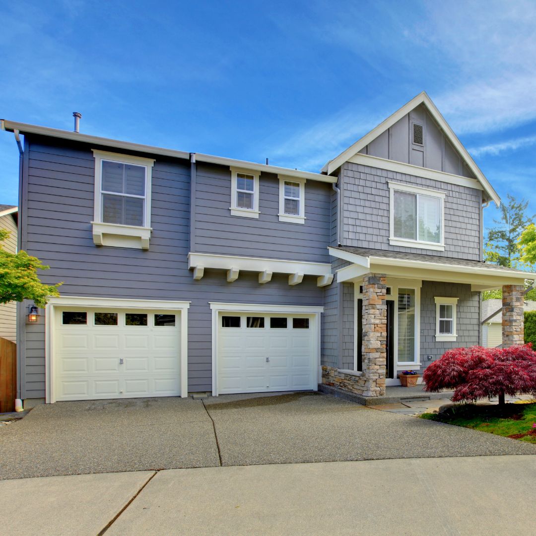 Two garage doors on big house