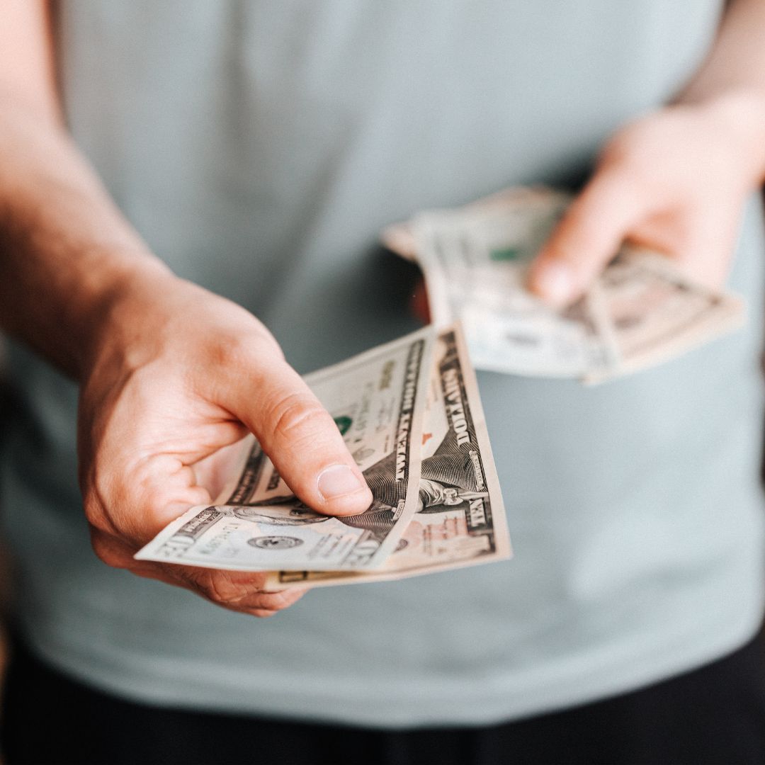 Person handing money over to someone