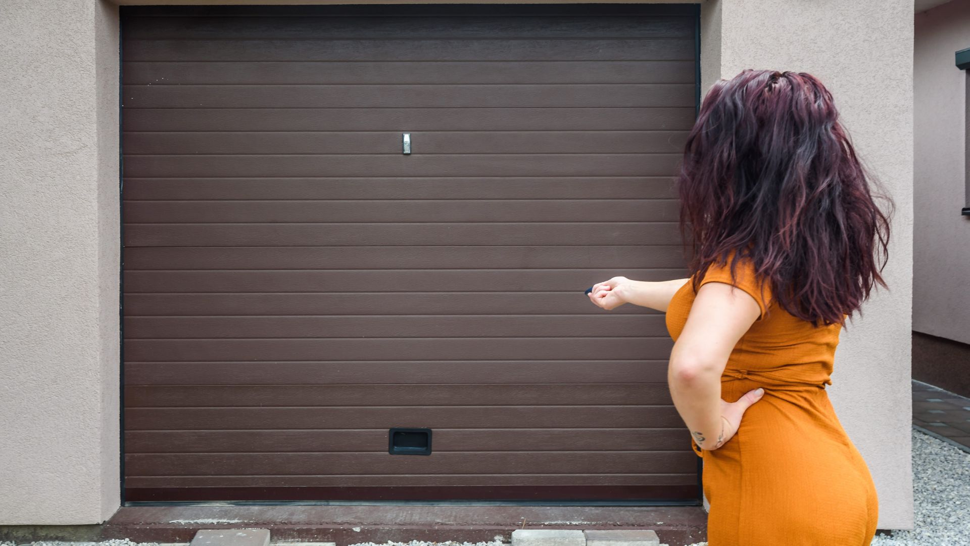 woman with a garage door remote in hand