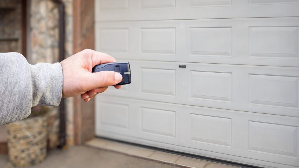 a garage door remote in hand