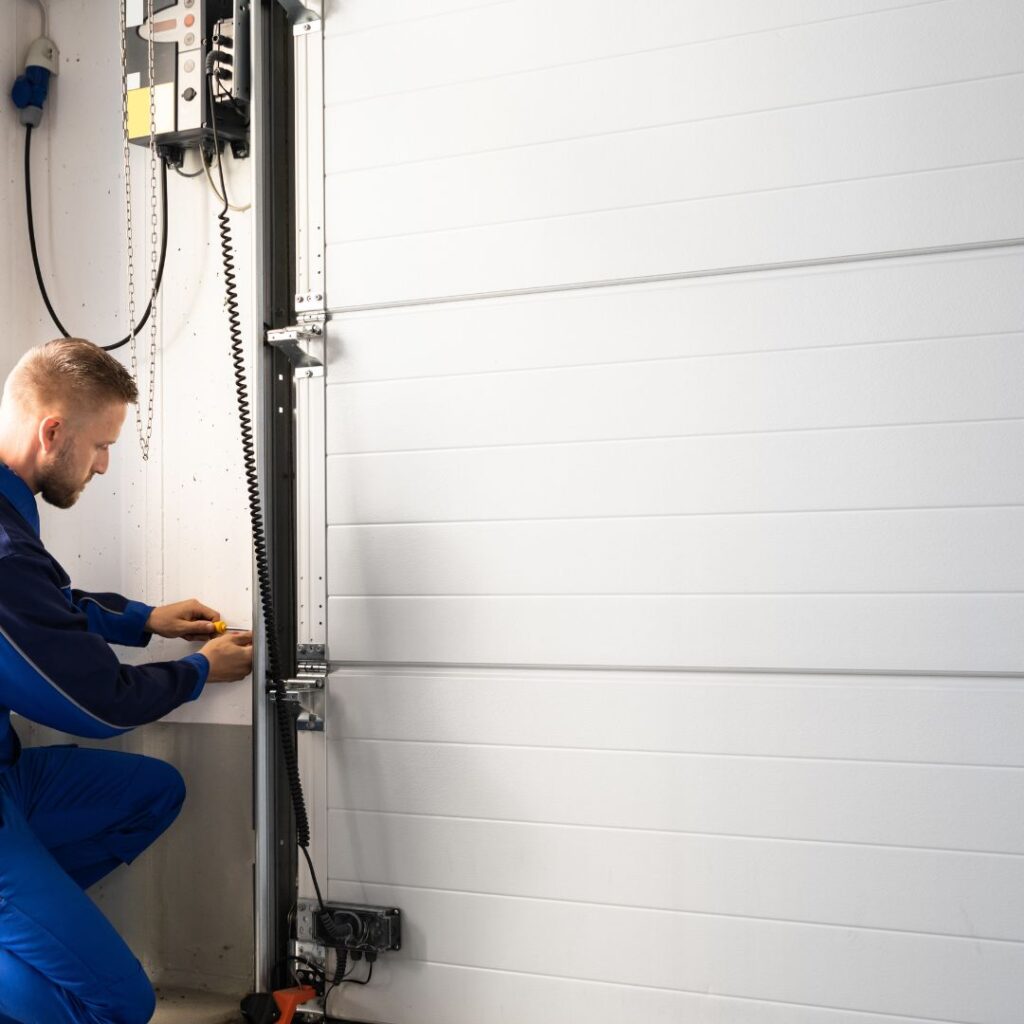 repairman fixing garage door rollers