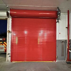 Closed bright red commercial roll-up garage door.